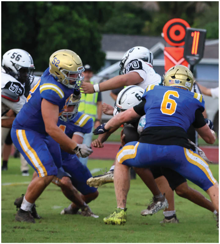 A group of football players wearing black and white uniforms. Description generated by AI