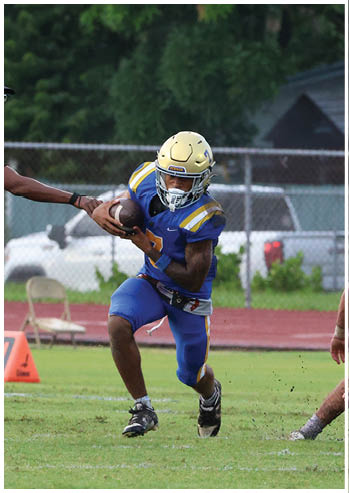A football player running on the field. Description generated by AI