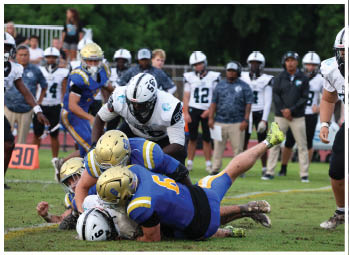 A football player is sliding on the ground. Description generated by AI