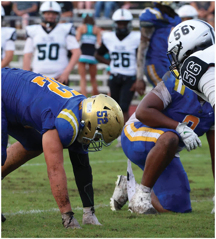 A group of football players wearing black and white uniforms. Description generated by AI