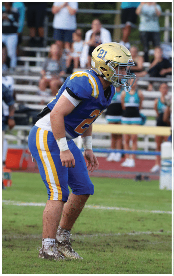 A football player running on the field. Description generated by AI