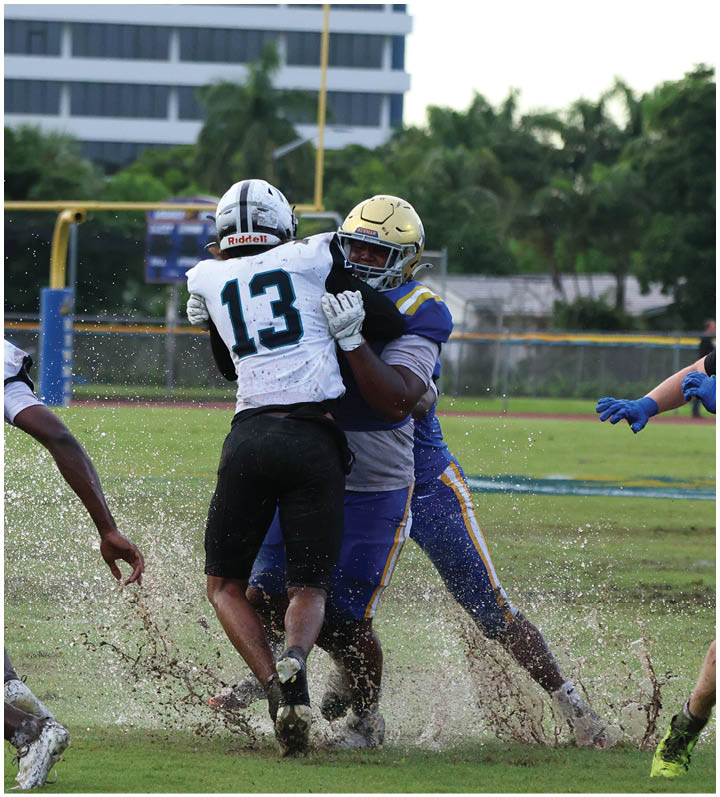 A group of football players wearing black and white uniforms. Description generated by AI
