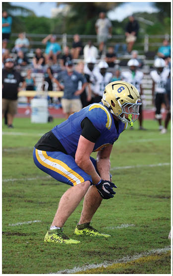 A football player running on the field. Description generated by AI