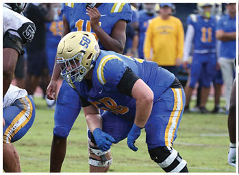 A football player is sliding on the ground. Description generated by AI