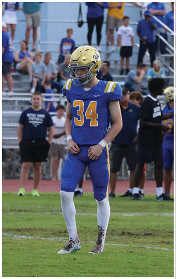 A football player running on the field. Description generated by AI