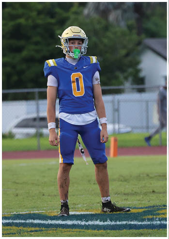 A football player running on the field. Description generated by AI