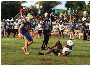 A football player is sliding on the ground. Description generated by AI