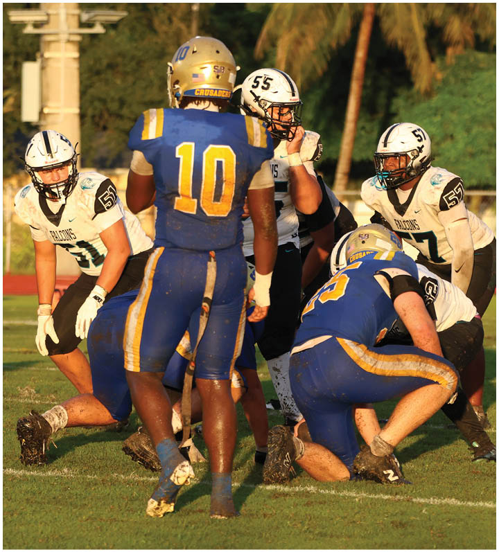 A group of football players wearing black and white uniforms. Description generated by AI