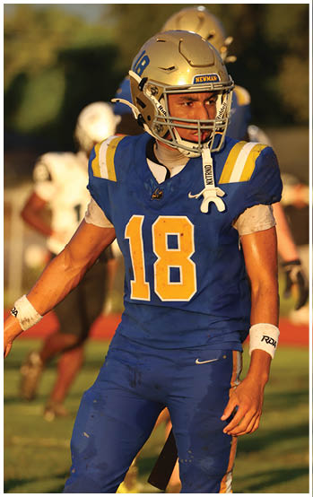 A football player running on the field. Description generated by AI