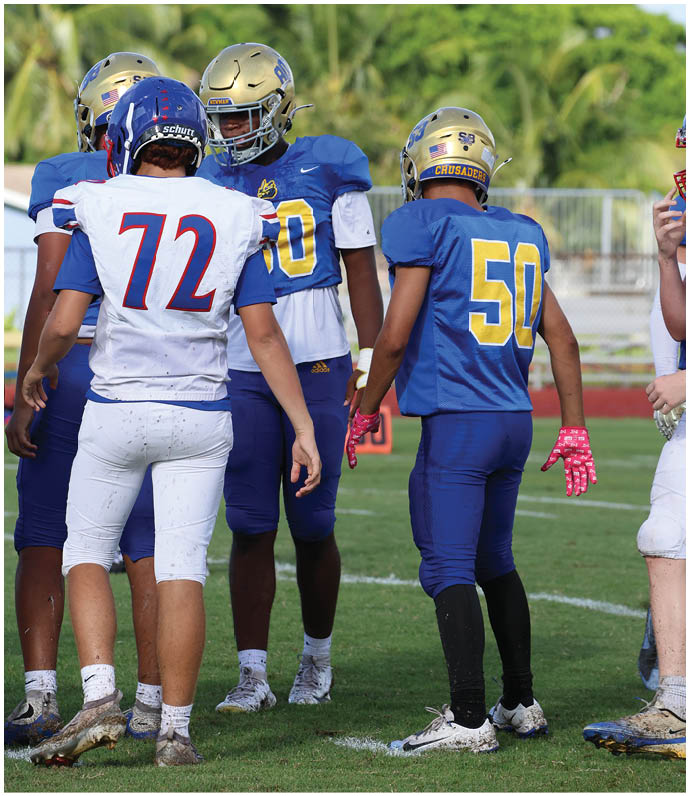 A group of football players wearing black and white uniforms. Description generated by AI
