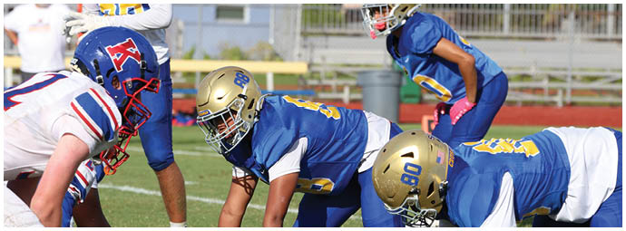 A football player is sliding on the ground. Description generated by AI