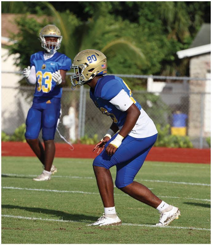 A group of football players wearing black and white uniforms. Description generated by AI