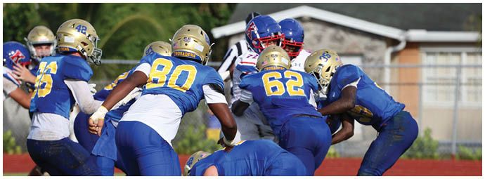 A football player is sliding on the ground. Description generated by AI