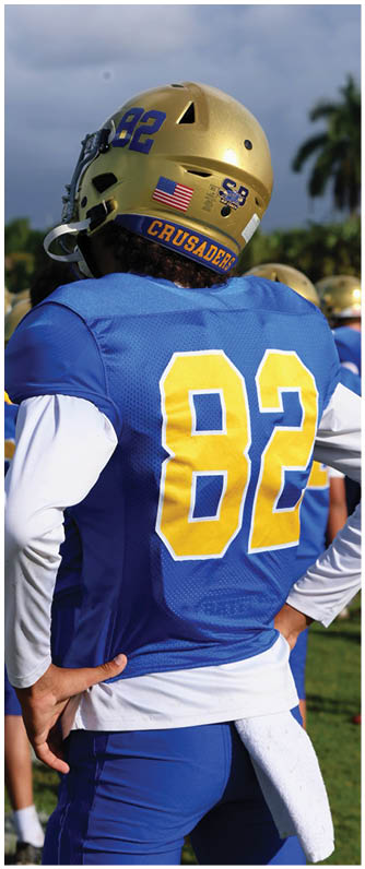 A football player running on the field. Description generated by AI