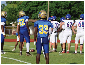 A football player is sliding on the ground. Description generated by AI