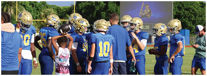 A football player is sliding on the ground. Description generated by AI