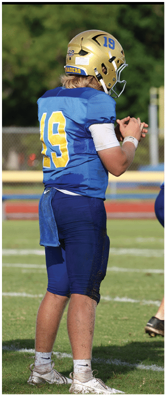 A football player running on the field. Description generated by AI
