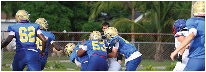 A group of football players on a field. Description generated by AI
