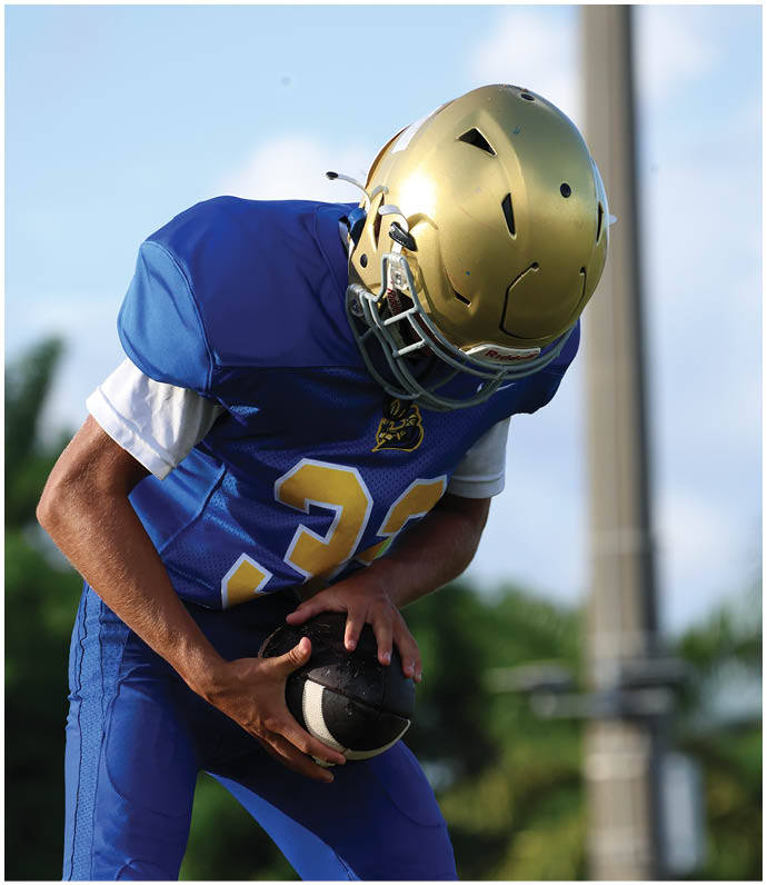 A group of football players wearing black and white uniforms. Description generated by AI