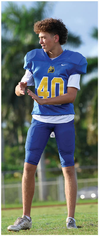 A football player running on the field. Description generated by AI
