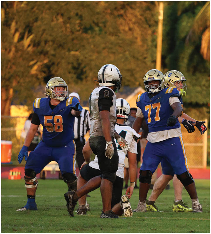 A group of football players wearing black and white uniforms. Description generated by AI
