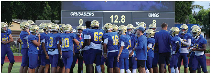 A group of football players on a field. Description generated by AI