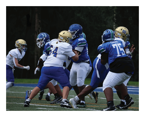 A man wearing a football uniform is jumping to catch a football. AI generated content