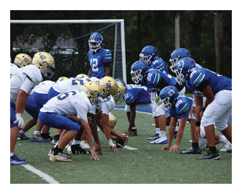 Two football players celebrating a touchdown with one player jumping in the air. AI generated content