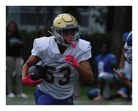 A man in a black jersey is running on a field with a football in his hand. AI generated content