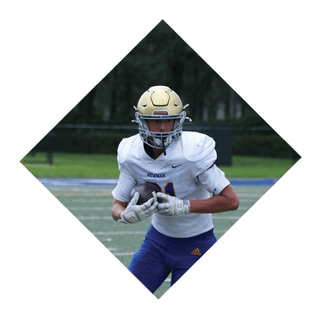 A football player wearing a black jersey with the number 3 kneels on the field. AI generated content