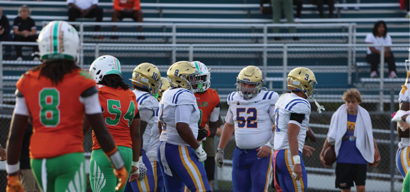 A group of people are kneeling on a field, possibly in a football game. AI generated content