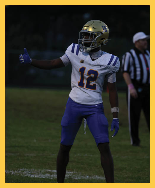 A football player in a white uniform is running with a football in his hand. AI generated content
