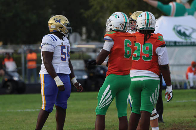 A group of football players in black and white uniforms are on the field. AI generated content