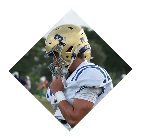 A football player wearing a black jersey with the number 3 kneels on the field. AI generated content