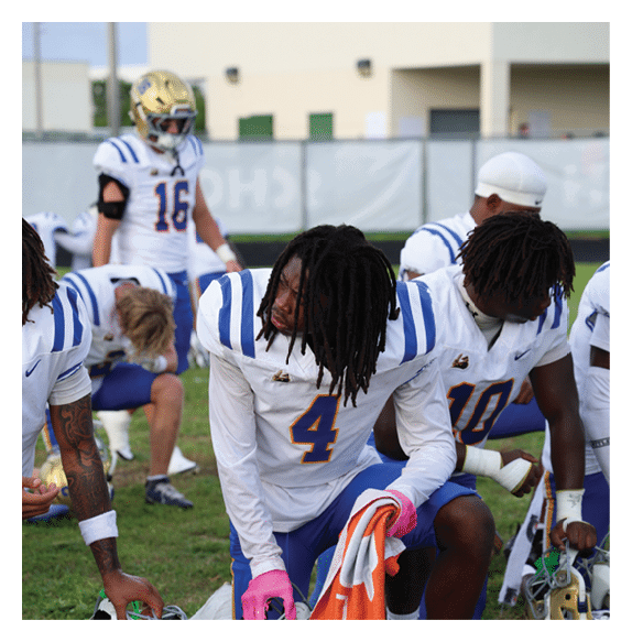 Two football players wearing Vista jerseys and holding hands. AI generated content