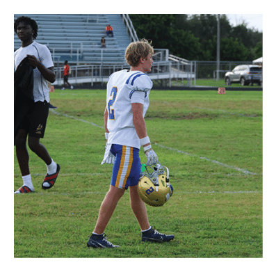 A football player in a white jersey with the number 85 on it is trying to catch a football. AI generated content