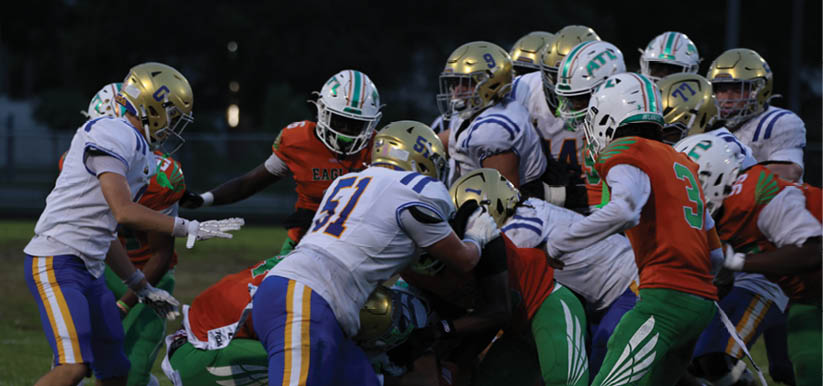 A group of people are kneeling on a field, possibly in a football game. AI generated content