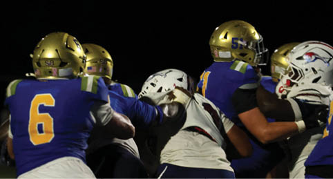 Two men wearing football uniforms are hugging each other on a field. AI generated content