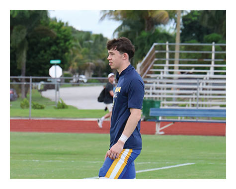 A man wearing a football uniform is jumping to catch a football. AI generated content