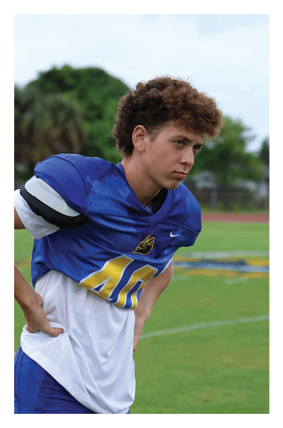 A young man wearing a football jersey with the name Vista on the back. AI generated content