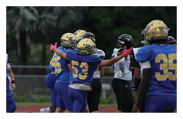 A group of people are kneeling on a field, possibly in a football game. AI generated content