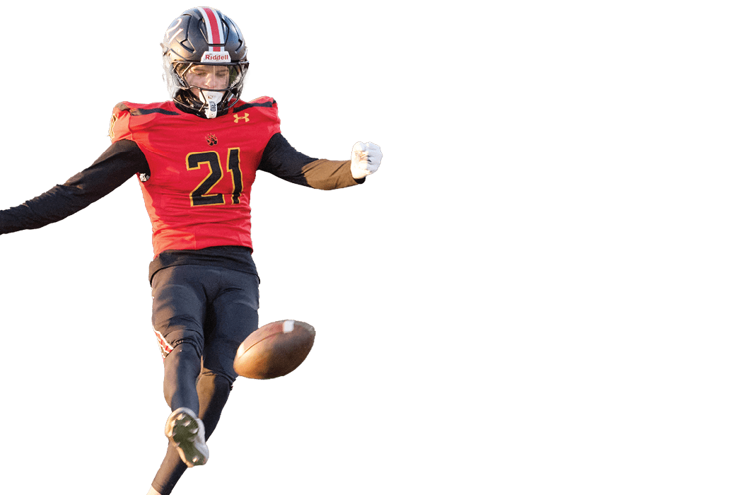 A person wearing a red and black football uniform with the number 21 and a helmet is in an action pose, appearing to be kicking or celebrating. Description generated by AI