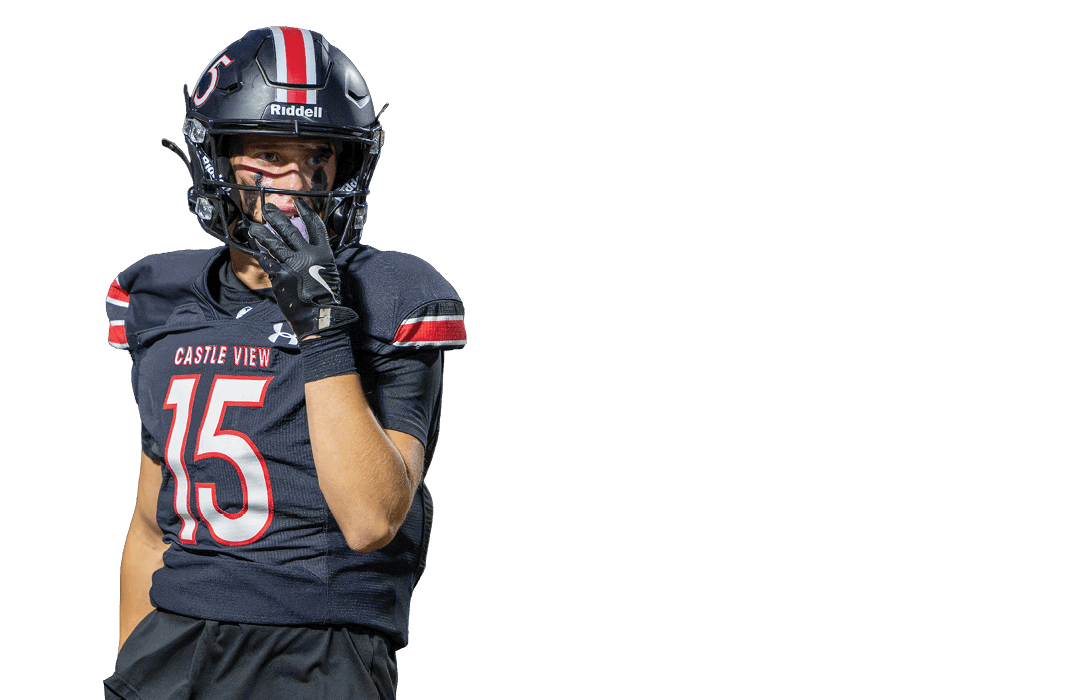 A person wearing a black football uniform and helmet with red and white stripes is holding their gloved hand near their face while looking to the side. Description generated by AI