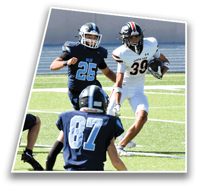 Three football players in action on a field with two wearing dark uniforms and one in a white uniform holding the ball. Description generated by AI