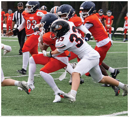 A football game is taking place with a group of men on the field. Description generated by AI