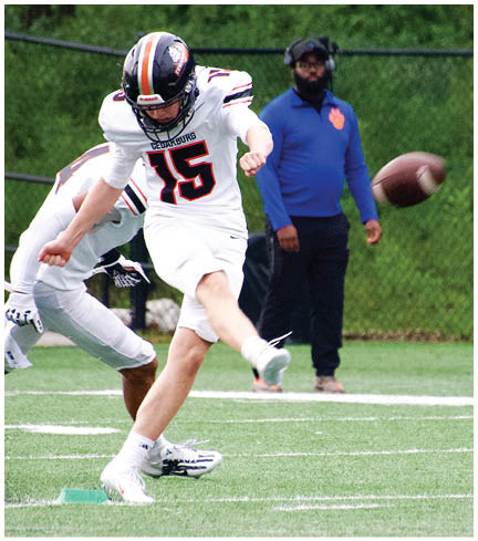 A football player wearing a blue and red jersey. Description generated by AI