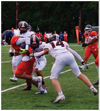 A group of football players celebrating a touchdown. Description generated by AI