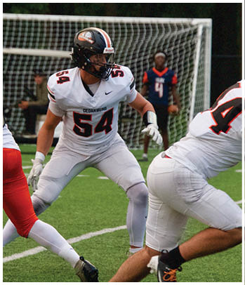 A group of football players celebrating a touchdown. Description generated by AI