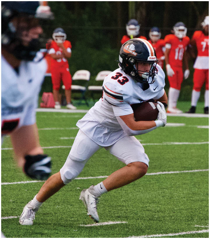 A group of football players on a field. Description generated by AI