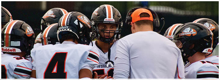 A group of football players on a field. Description generated by AI